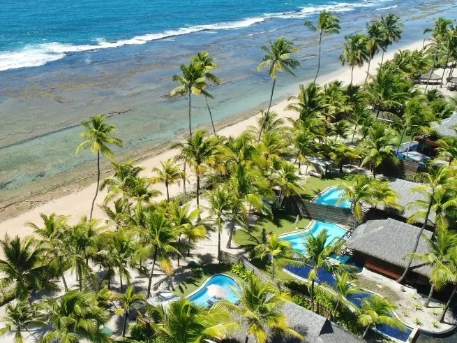 Praia de Muro Alto com coqueiros e o mar com arrecifes, em frente ao NANNAI