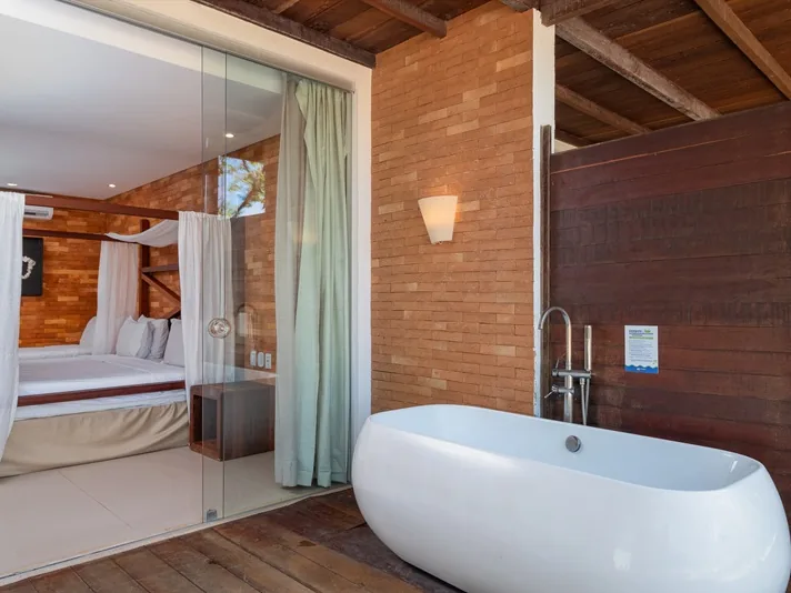 Acomodação Premium Class Pé na Areia do Pratagy Beach Resort, com a banheira na varanda e a cama com dossel ao fundo